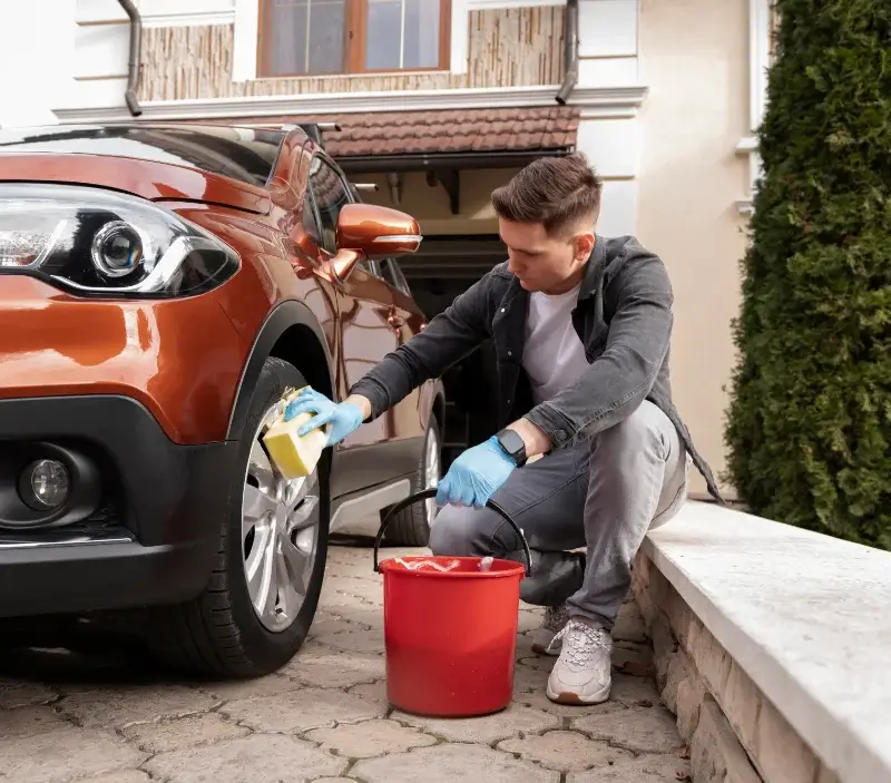 Lavage auto à domicile Allondrelle-la-Malmaison : professionnel intervenant sur un véhicule